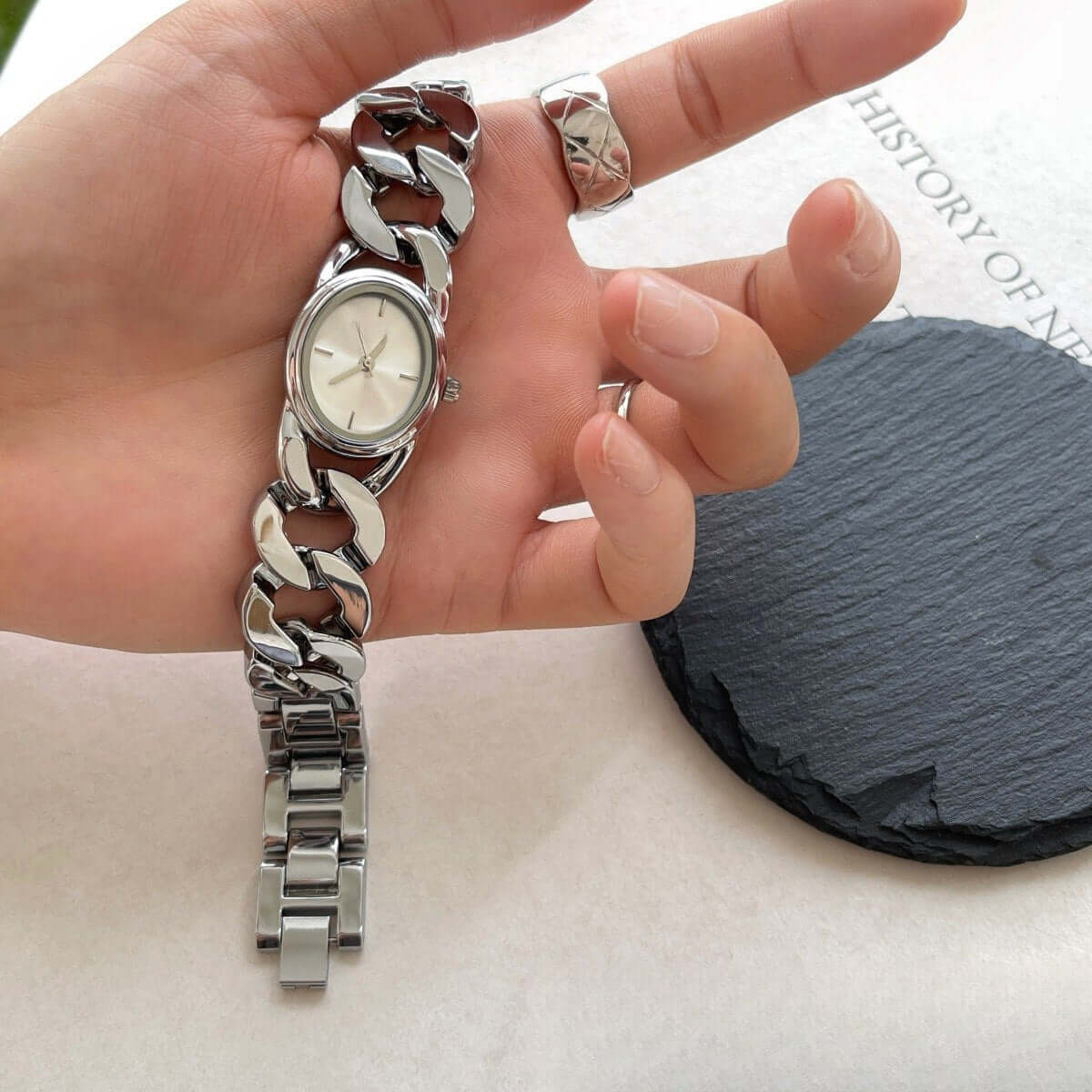 A stylish vintage watch in UAE showcased on a hand, with a unique chain design, reflecting elegance.